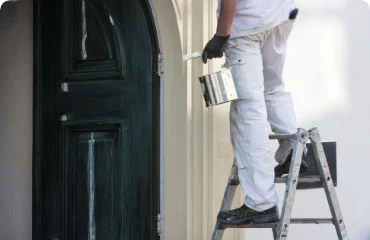 Dickerson Custom Painting painter in Bay County Florida painting a residential property with custom services
